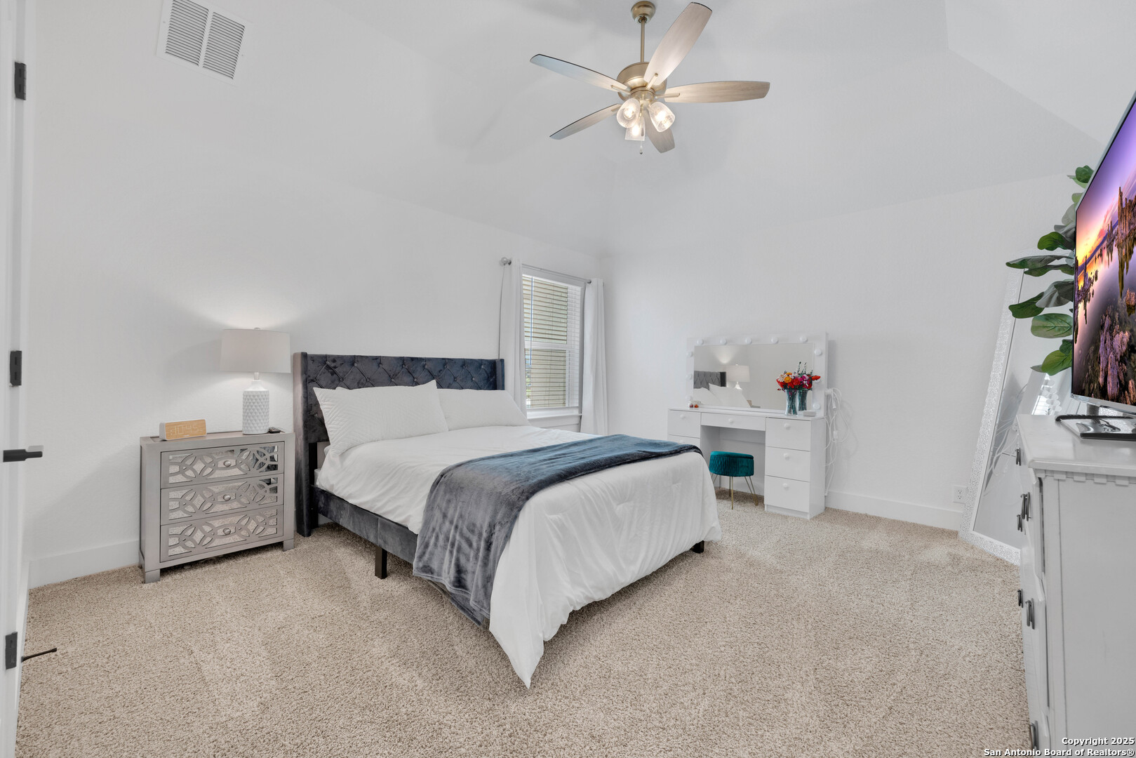 235 Corazon Boerne, TX 78006 - Photo 54 of 68 a bedroom with a bed and a chandelier