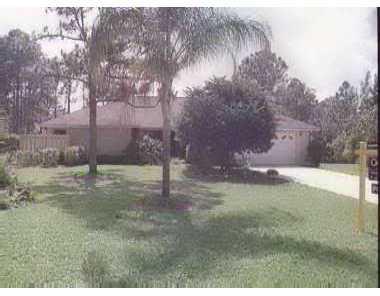 2063 Southwest Pitts Terrace Stuart, FL 34997 - Photo 1 of 1 a backyard of a house with lots of green space