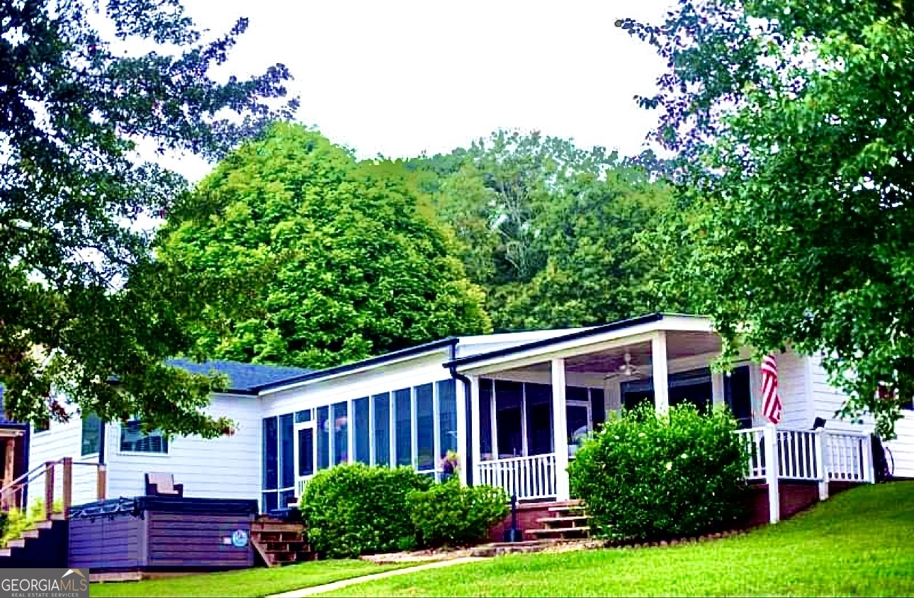 212 A Roberts Point Road Jackson, GA 30233 - Photo 1 of 1 a view of a yard in front of a house with plants and large tree