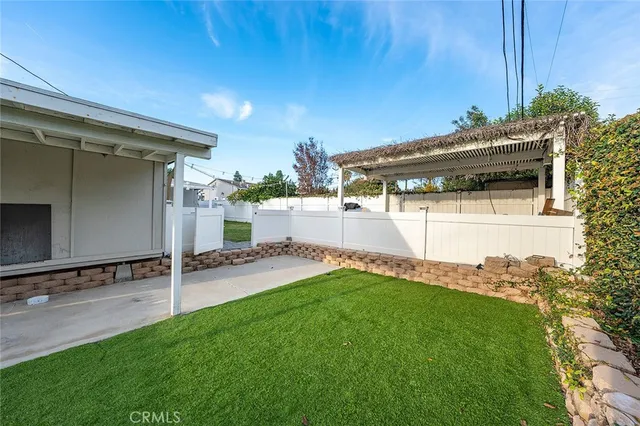a view of a backyard with plants and a patio
