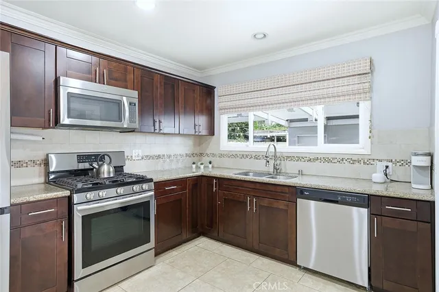 a kitchen with a sink stove and microwave