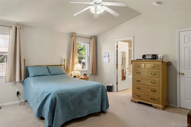 a spacious bedroom with a bed and a chandelier