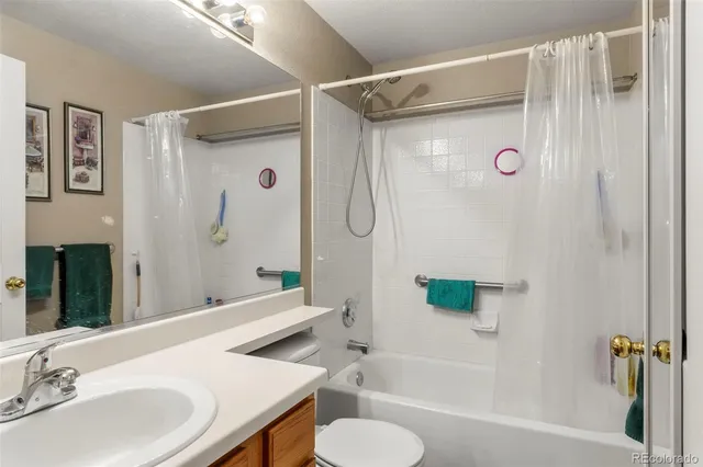a bathroom with a sink toilet tub and shower