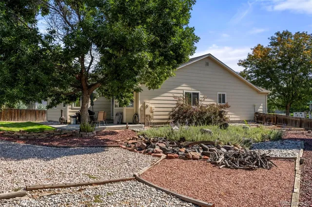 a backyard of a house with outdoor seating