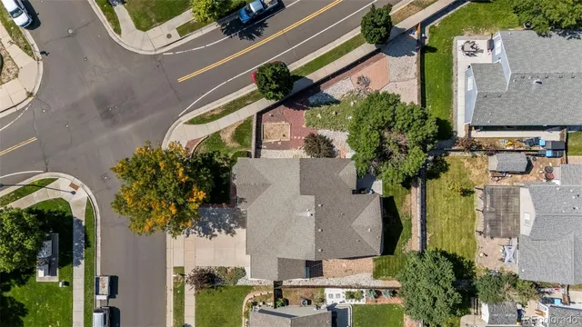 an aerial view of a house with a garden and trees