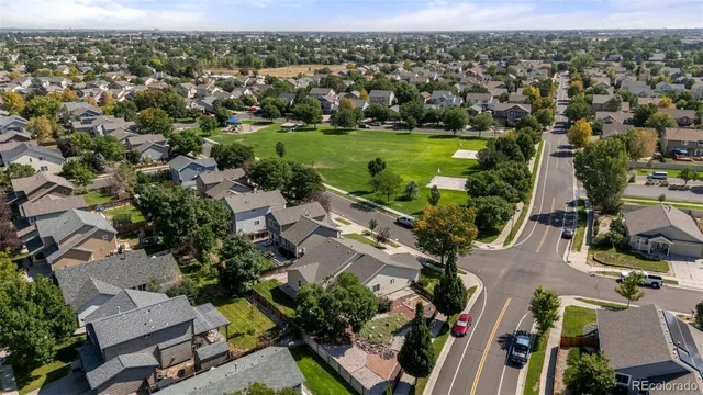 an aerial view of residential houses with outdoor space and river