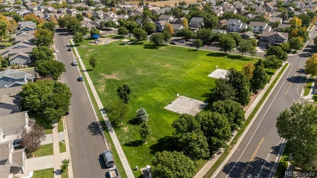 an aerial view of residential houses with outdoor space and swimming pool