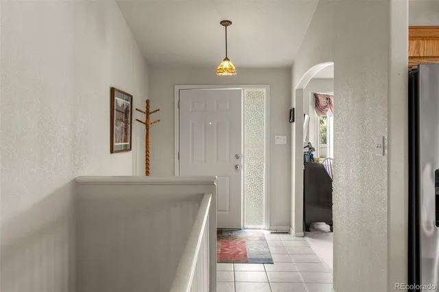 a view of a hallway to a livingroom with furniture