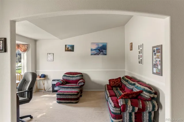 a bedroom with furniture and a chair