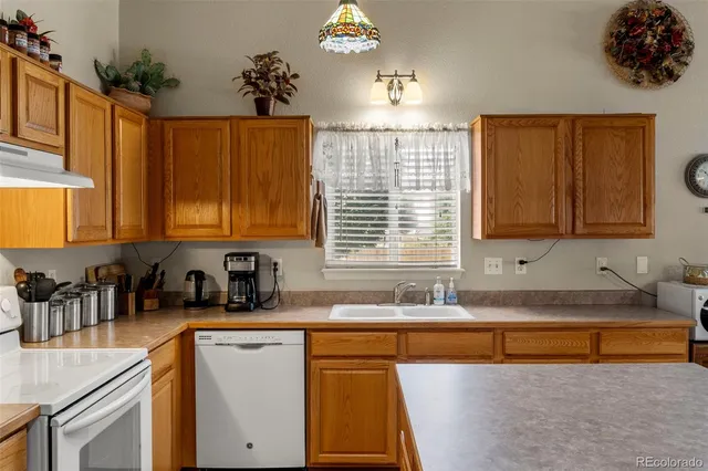 a kitchen with a sink a counter top space and cabinets