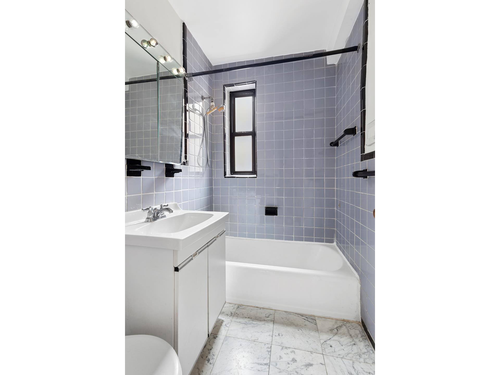 330 East 70th Street, Unit 6E Manhattan, NY 10021 - Photo 5 of 9 a bathroom with a sink toilet and shower