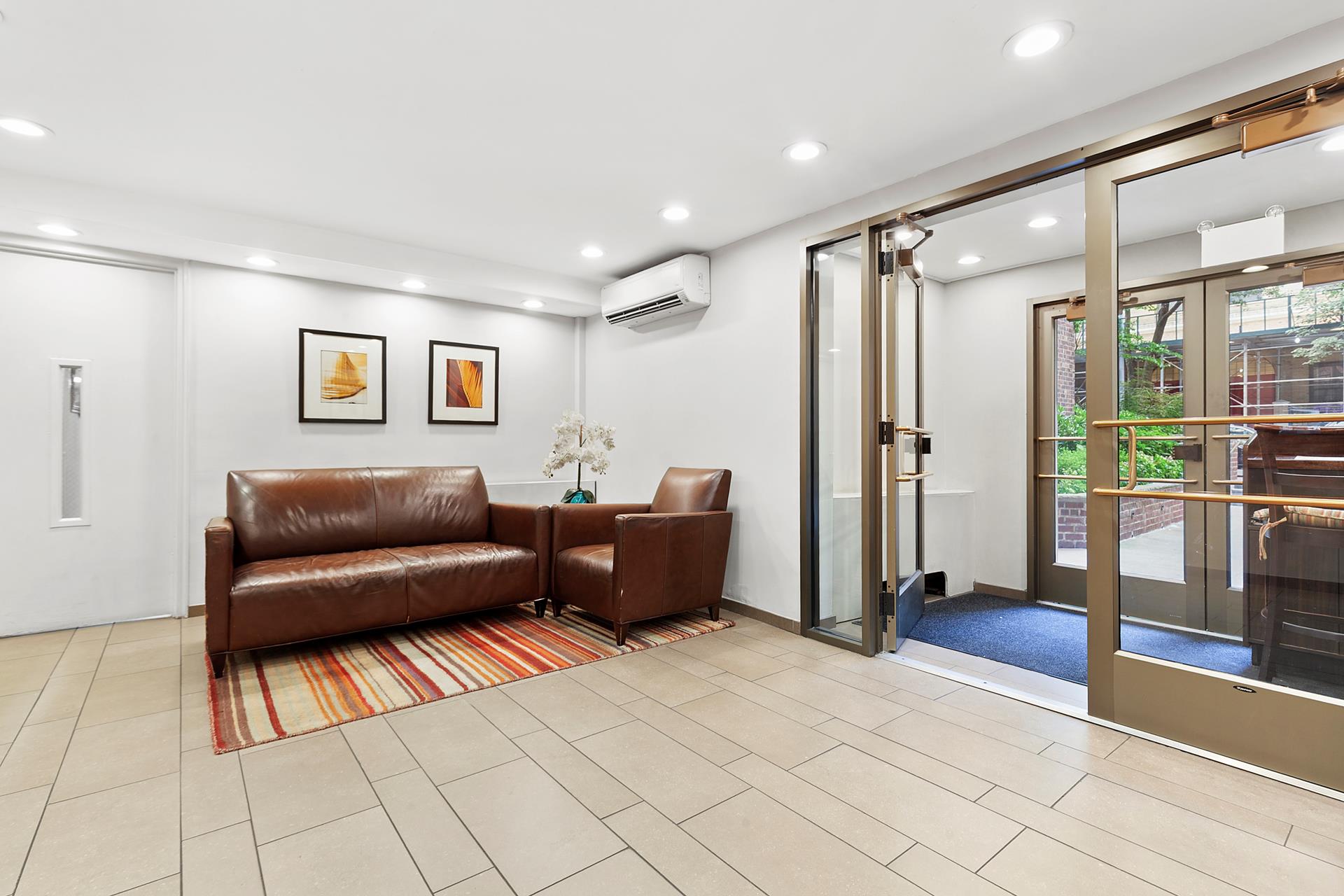 330 East 70th Street, Unit 6E Manhattan, NY 10021 - Photo 6 of 9 a living room with furniture and a rug