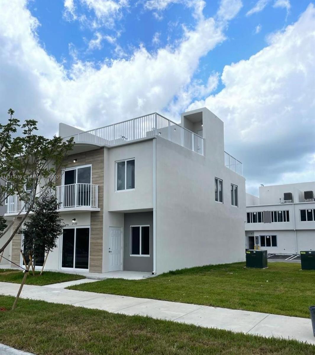 a front view of a house with a garden