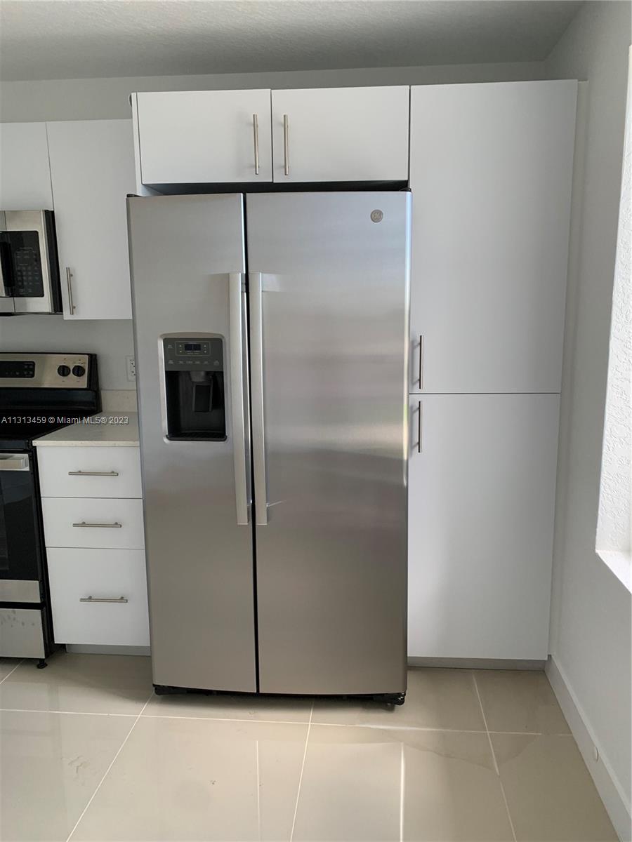 25680 Southwest 143rd Avenue Homestead, FL 33032 - Photo 3 of 20 a kitchen with cabinets and stainless steel appliances