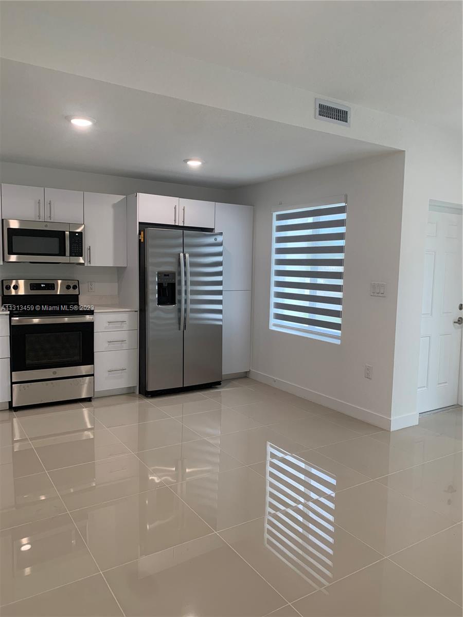 25680 Southwest 143rd Avenue Homestead, FL 33032 - Photo 5 of 20 a view of kitchen with sink and microwave