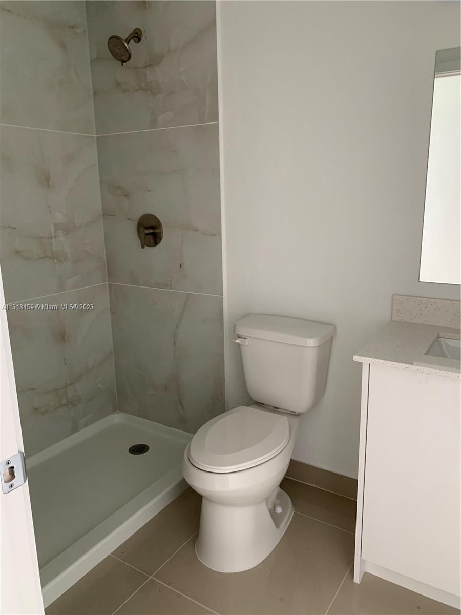 25680 Southwest 143rd Avenue Homestead, FL 33032 - Photo 6 of 20 a white toilet sitting next to a bath tub shower