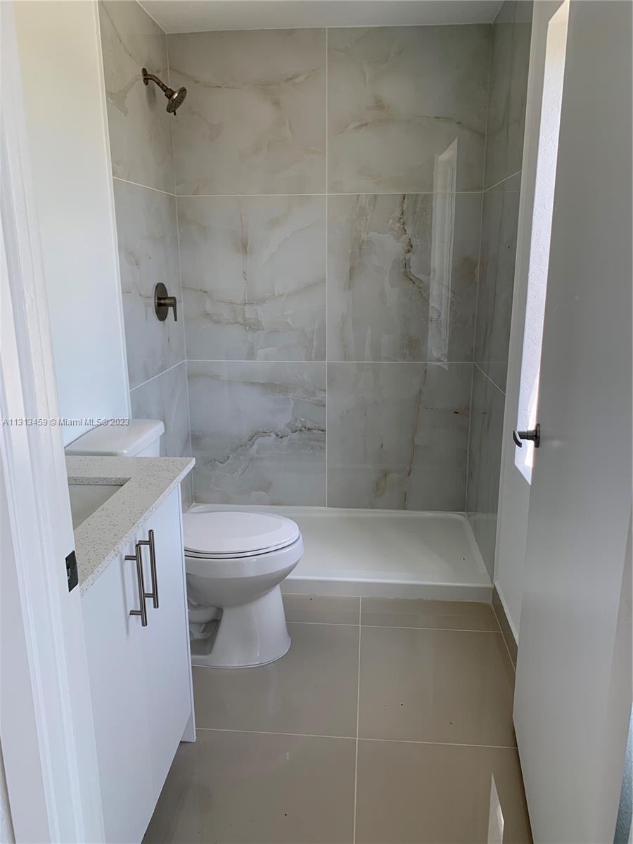 25680 Southwest 143rd Avenue Homestead, FL 33032 - Photo 7 of 20 a bathroom with a toilet a sink and shower