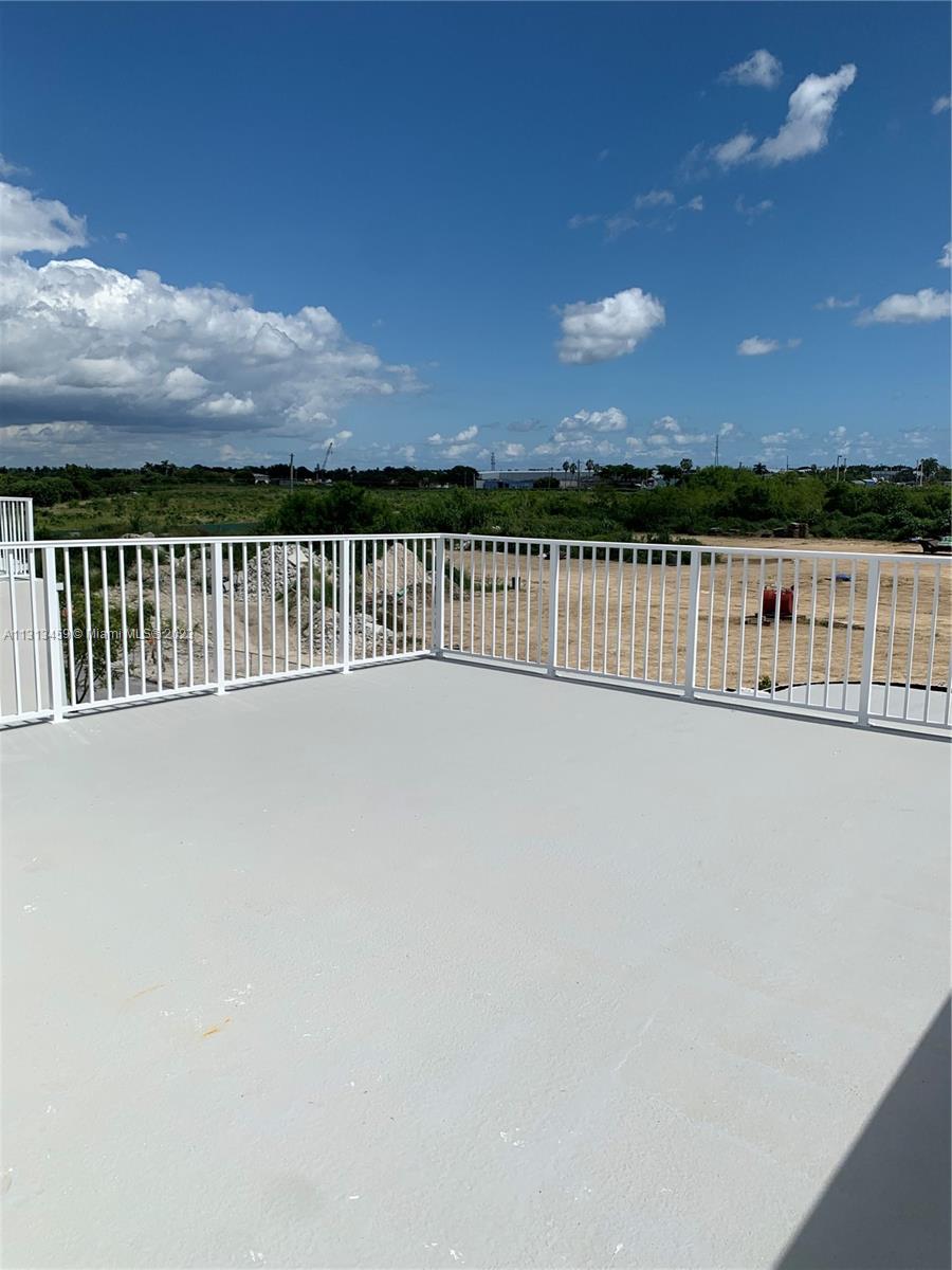 25680 Southwest 143rd Avenue Homestead, FL 33032 - Photo 10 of 20 a view of balcony with floor to ceiling windows