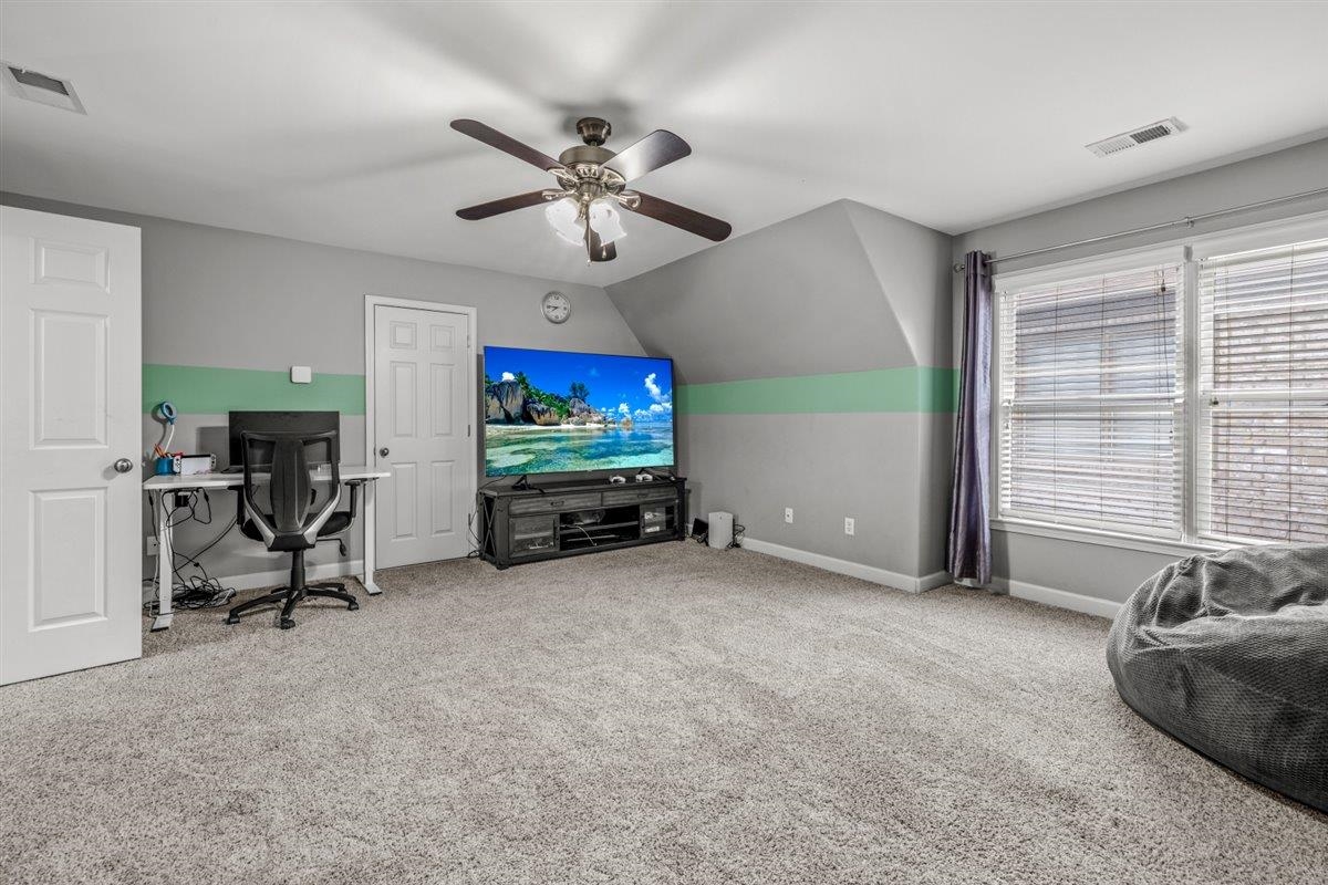 744 Southern Home Road Collierville, TN 38017 - Photo 16 of 24 Carpeted room featuring a ceiling fan with integrated lighting, two windows with blinds, and white trim throughout