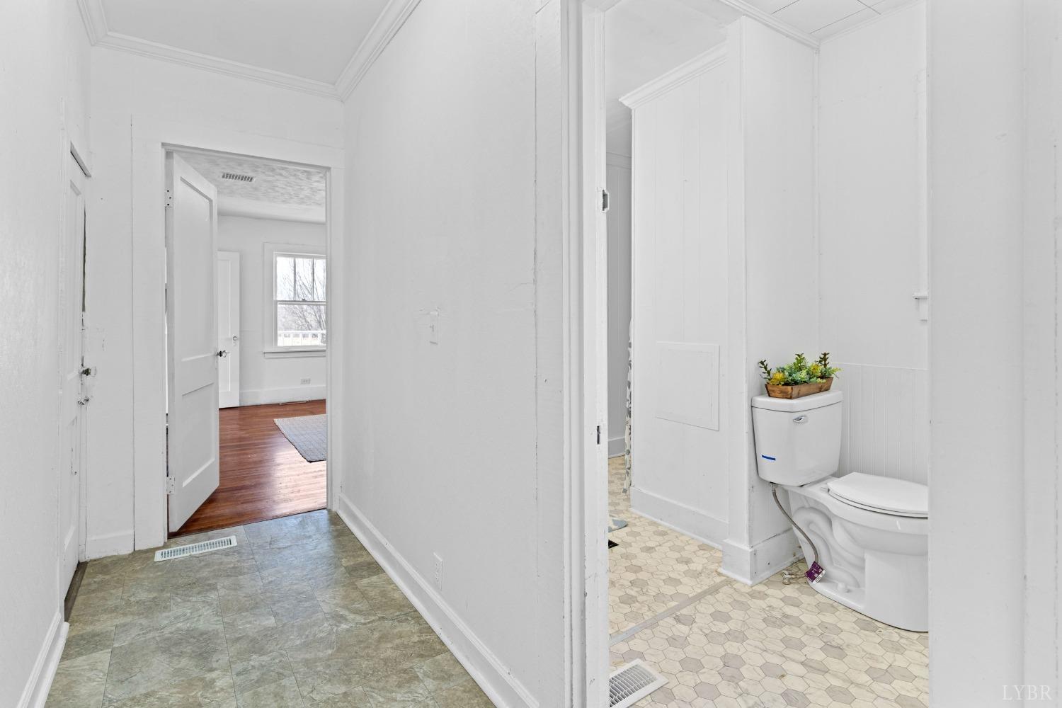 4769 Spring Garden Road Chatham, VA 24531 - Photo 19 of 44 a view of a hallway with wooden floor and a bathroom