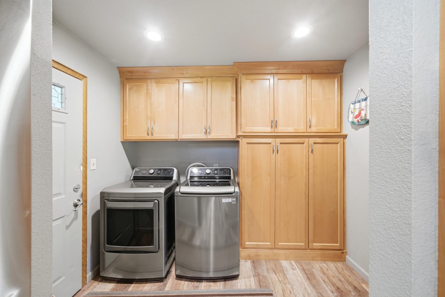 15828 Barney Road Plymouth, CA 95669 - Photo 15 of 71 a kitchen with a stove a fridge and white cabinets