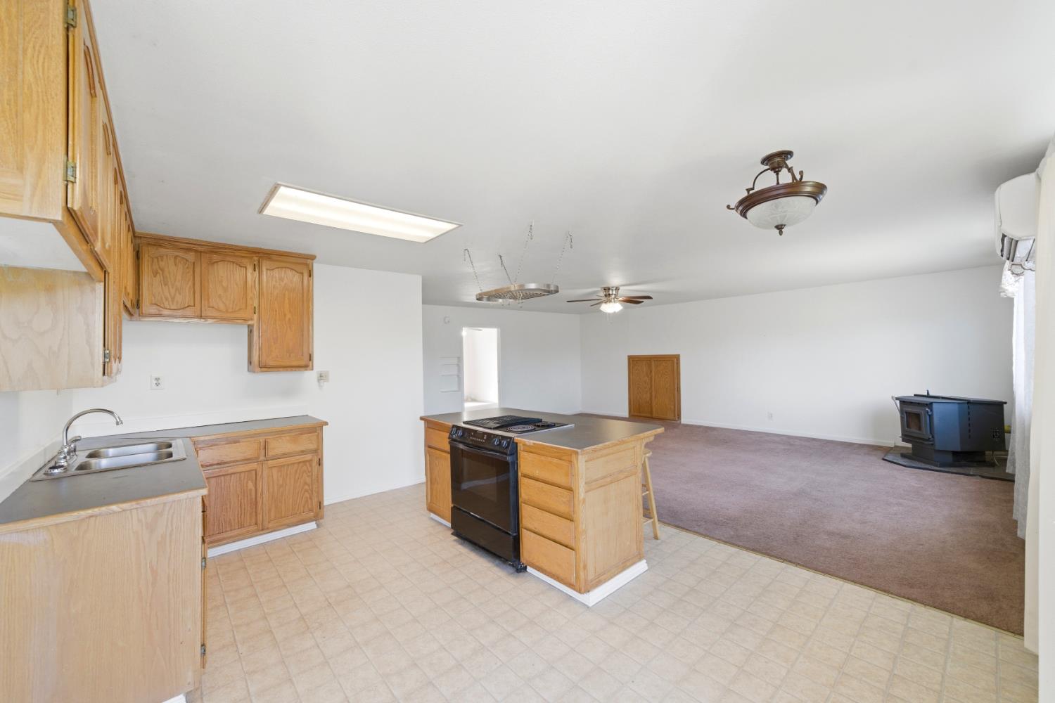 15828 Barney Road Plymouth, CA 95669 - Photo 28 of 71 a kitchen with stainless steel appliances granite countertop a stove and a sink with cabinets