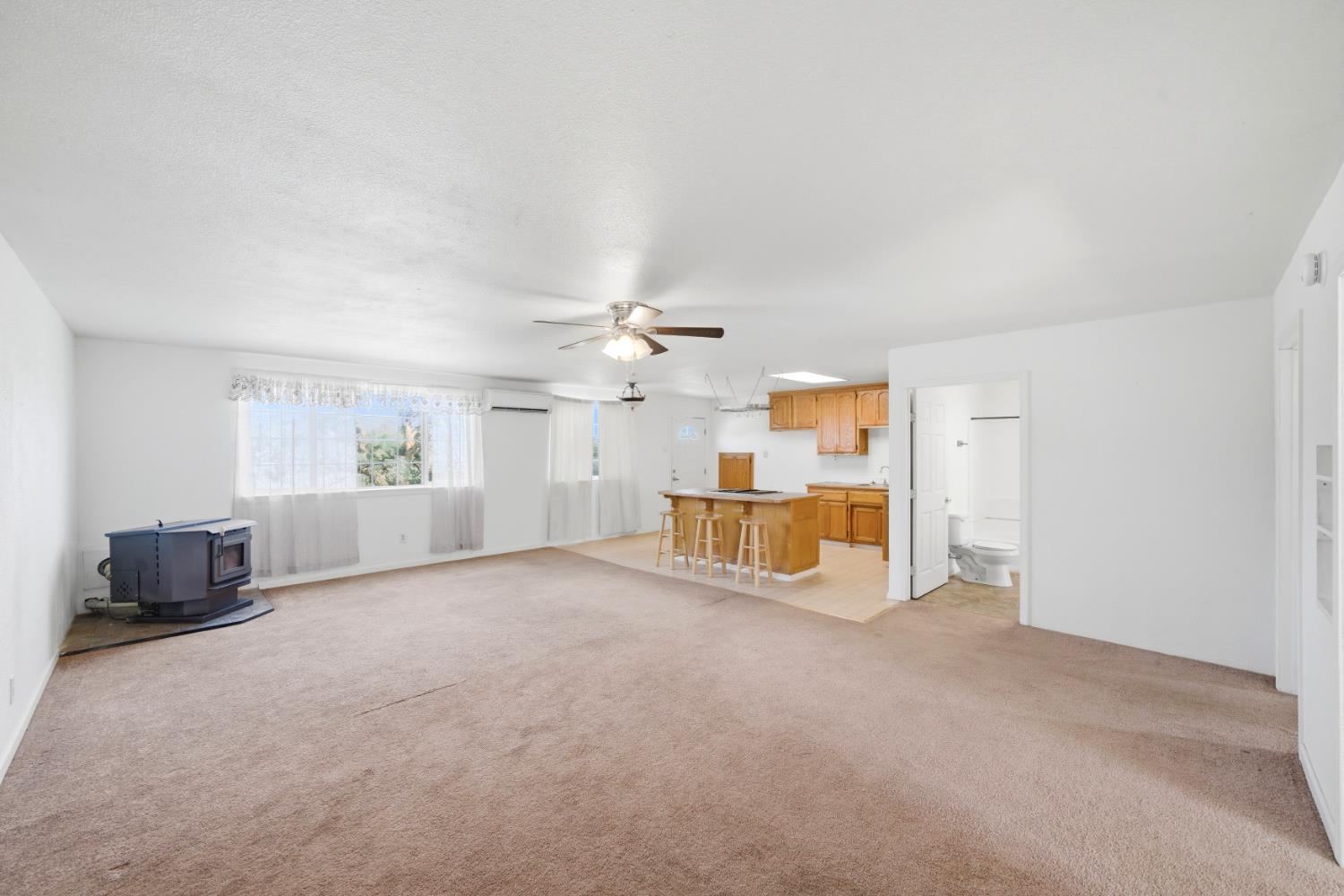 15828 Barney Road Plymouth, CA 95669 - Photo 35 of 71 an empty room with windows and fireplace