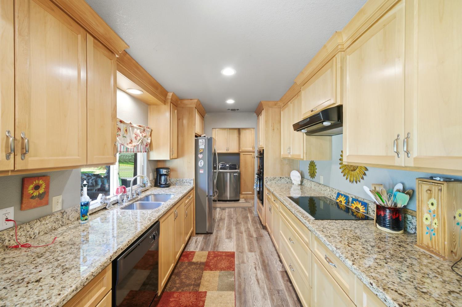 15828 Barney Road Plymouth, CA 95669 - Photo 9 of 71 a kitchen with stainless steel appliances granite countertop sink stove top oven and cabinets
