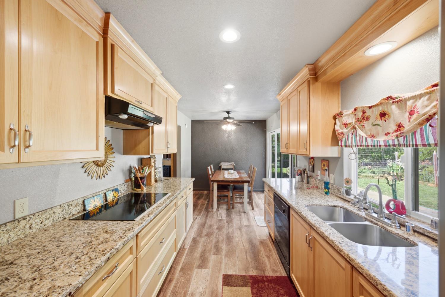15828 Barney Road Plymouth, CA 95669 - Photo 10 of 71 a large kitchen with a large window and stainless steel appliances