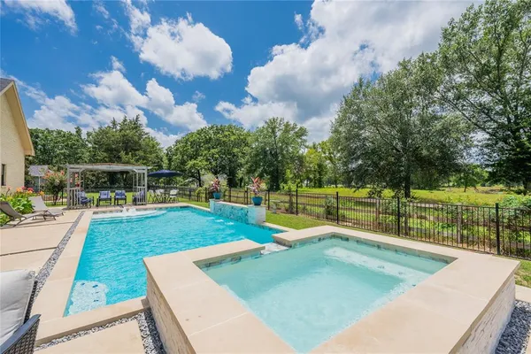 a view of a swimming pool with a patio