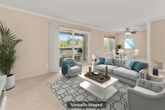 a living room with furniture and a potted plant