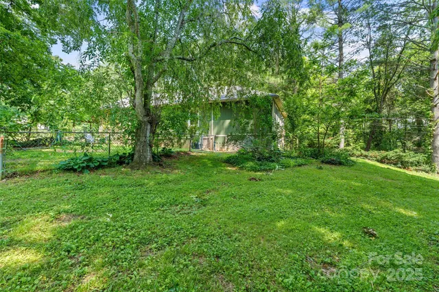 a view of a green field with trees