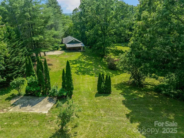 a view of a lush green hillside and a building