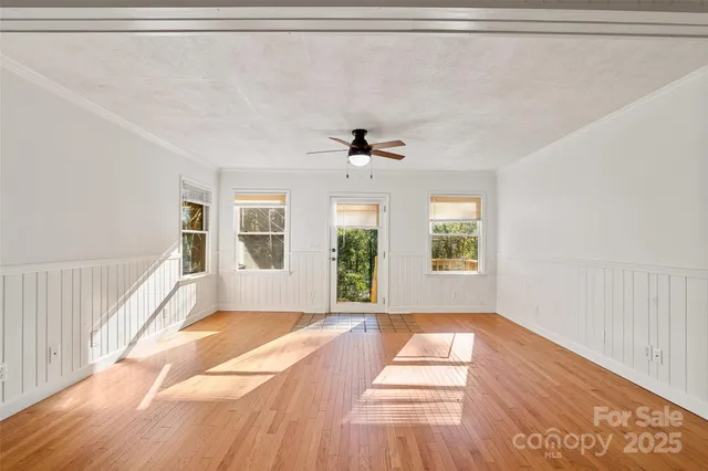 a furnished livingroom with a ceiling fan