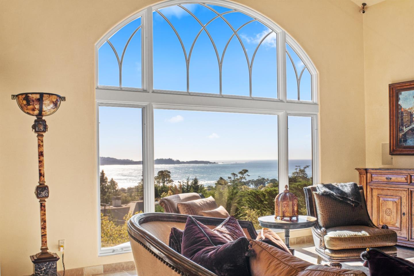 a living room with furniture a window and a floor to ceiling window