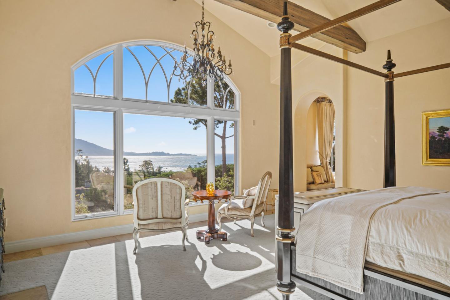 1519 Riata Road Pebble Beach, CA 93953 - Photo 24 of 75 a bedroom with a bed a table and chair with the large mirror