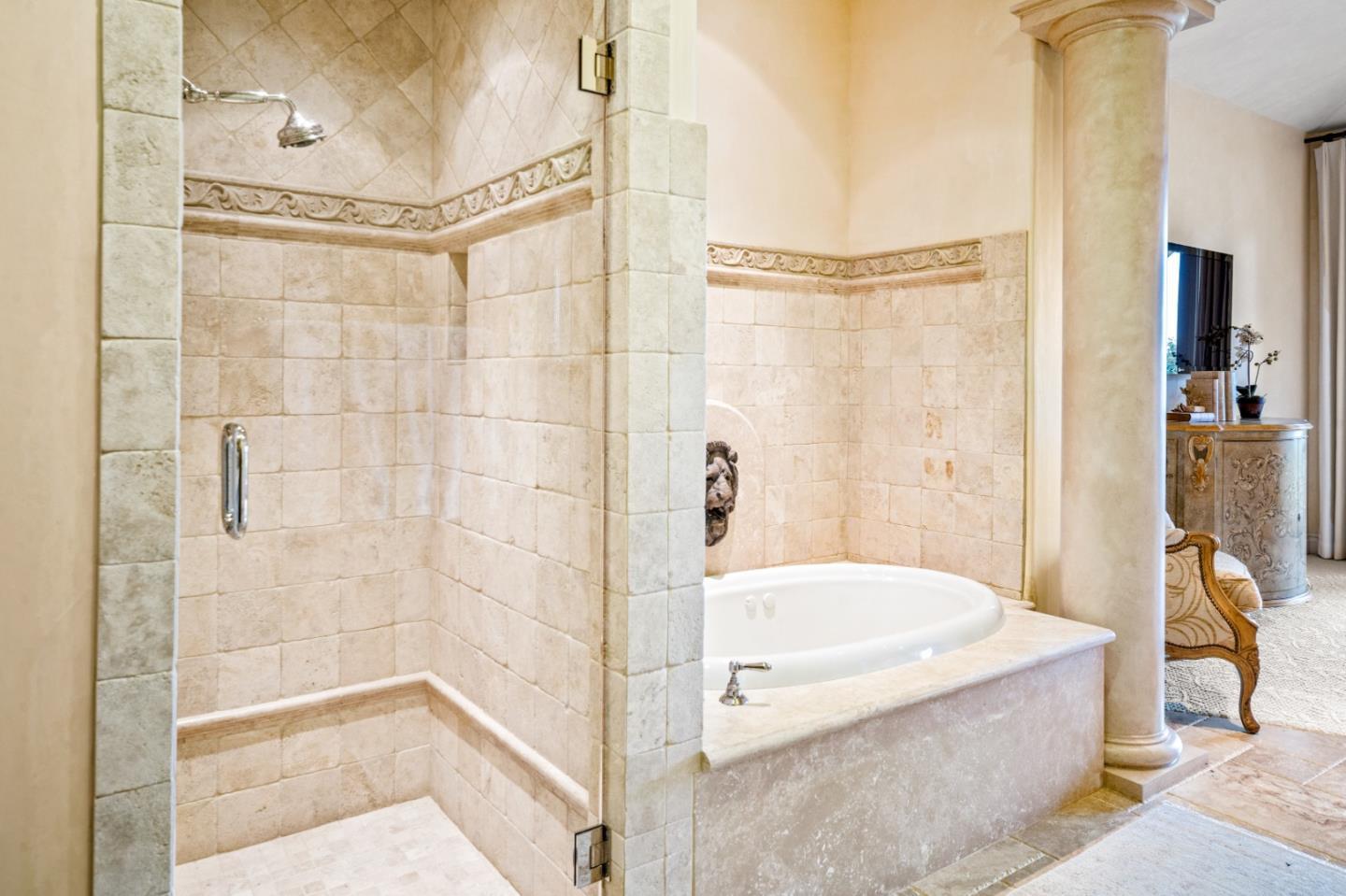 1519 Riata Road Pebble Beach, CA 93953 - Photo 52 of 75 a bathroom with a tub and shower