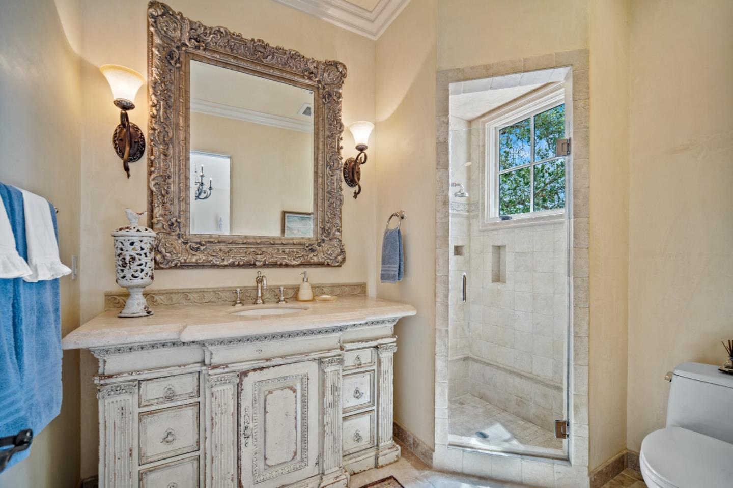 1519 Riata Road Pebble Beach, CA 93953 - Photo 66 of 75 a bathroom with a granite countertop sink a mirror and a shower