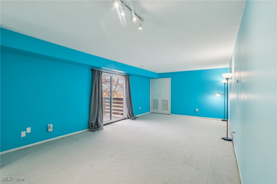 3484 Mayfield Road, Unit 3426 Cleveland Heights, OH 44118 - Photo 27 of 33 Carpeted spare room with track lighting and baseboards