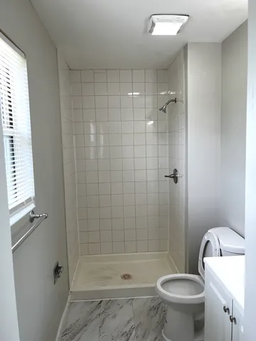 a bathroom with a toilet and shower