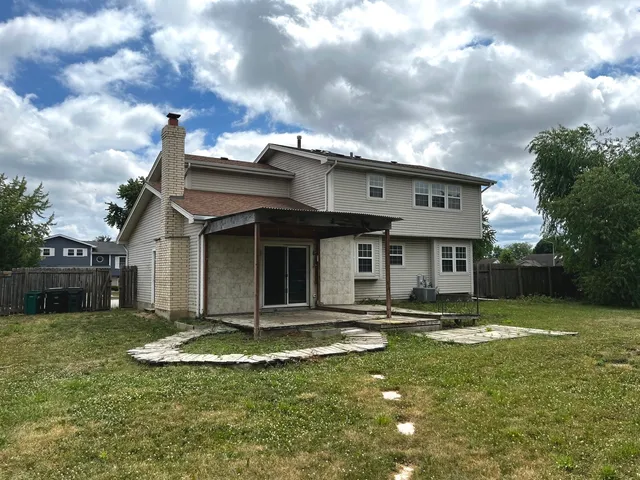 a view of a white house with a swimming pool and a yard