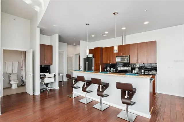 a living room with furniture wooden floor and a large window