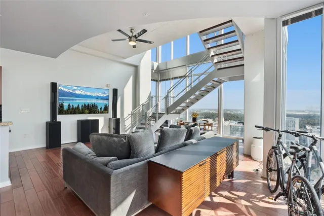 a bathroom with a granite countertop sink toilet mirror and shower