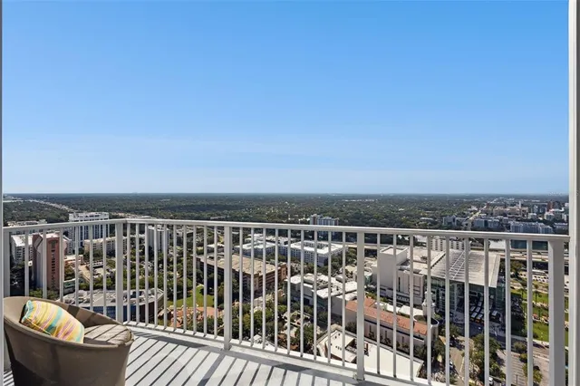 a view of a patio with table and chairs and a large tree