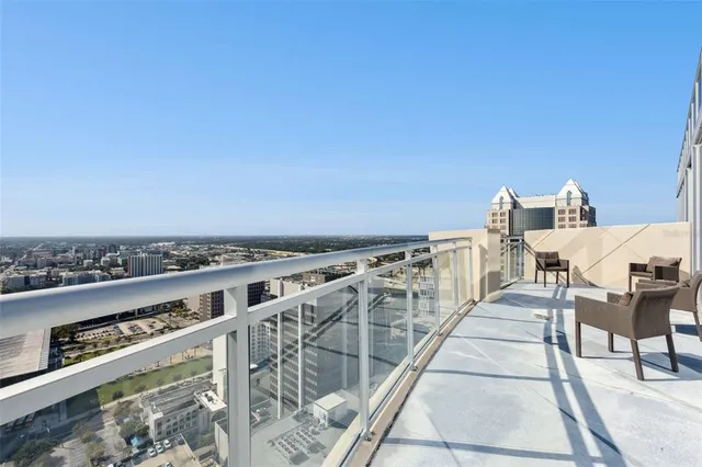 a front view of a building with lots of green space and plants