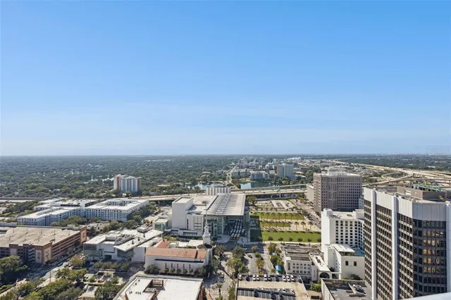 a view of a backyard with plants and outdoor seating