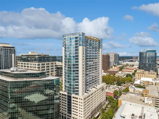 a large kitchen with lots of counter space a sink and chairs