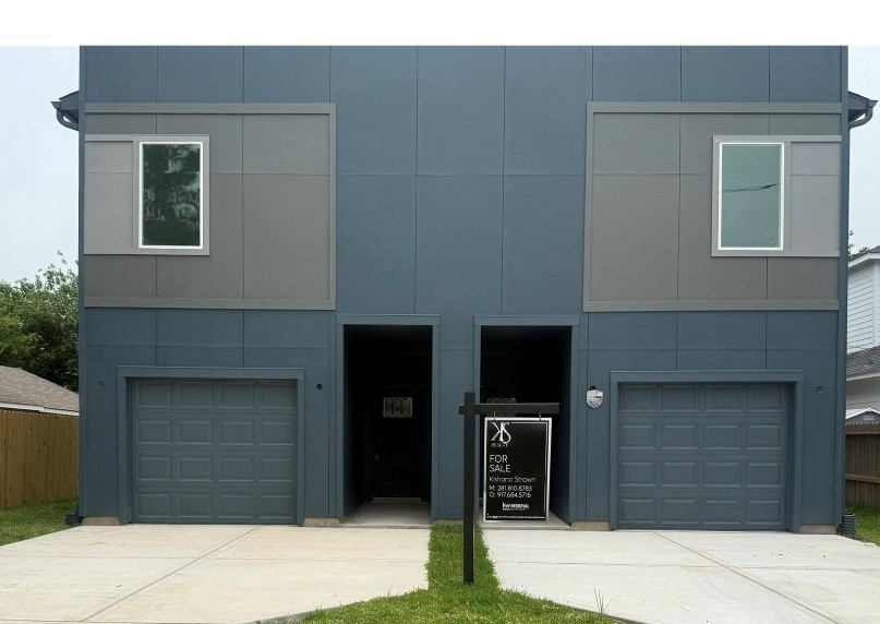 a front view of a house with garage