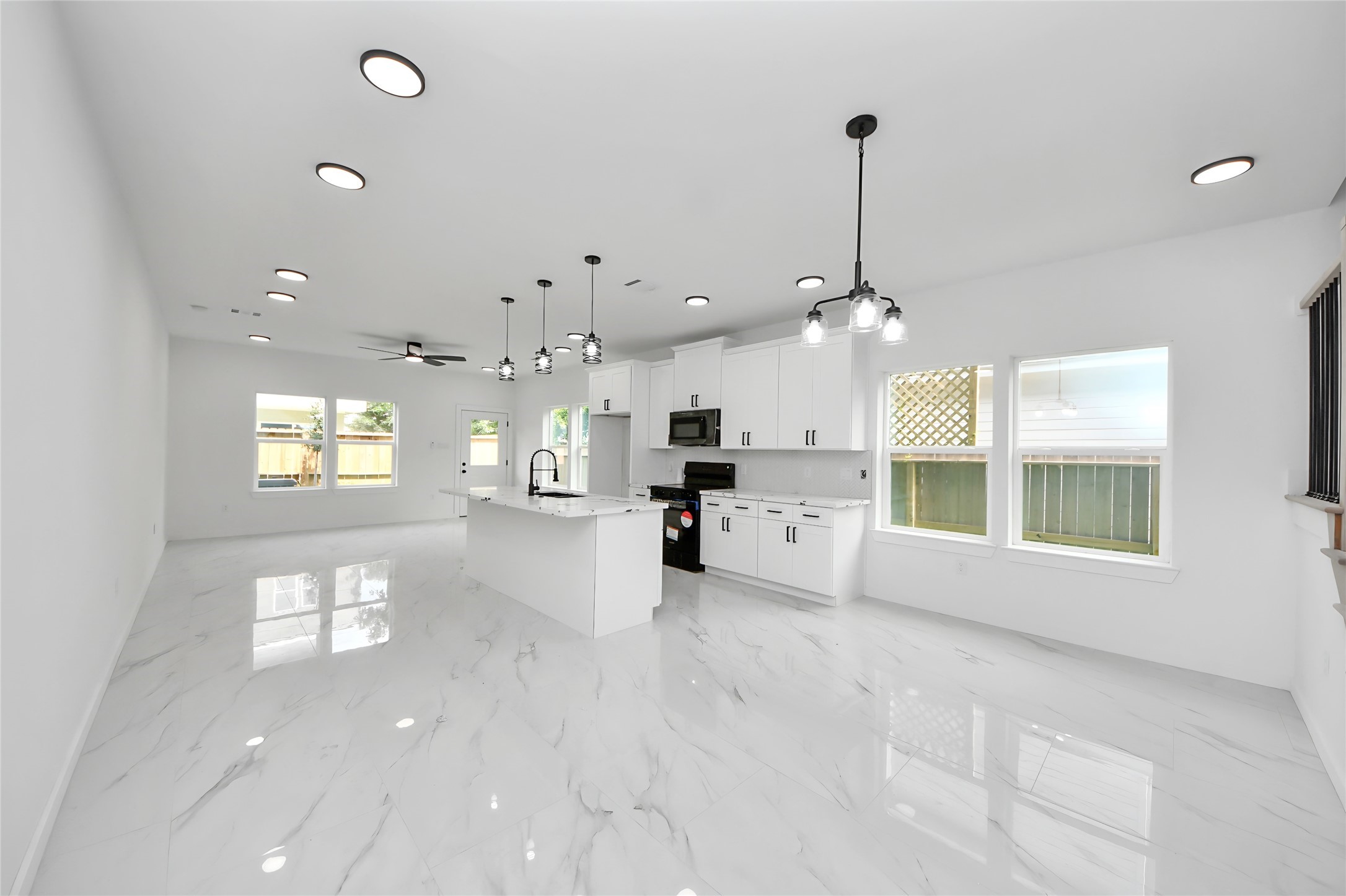 8023 Brandon Street Houston, TX 77051 - Photo 2 of 10 a view of a kitchen with granite countertop a stove and a chandelier