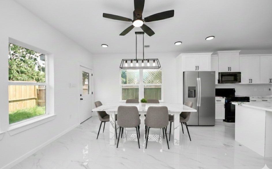 8023 Brandon Street Houston, TX 77051 - Photo 3 of 10 a view of a dining room with furniture window and wooden floor